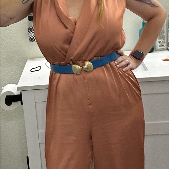 This silky romper is super cute. I am 5’5” & 135 lbs. it’s a salmon/ginger color - Picture 1 of 7
